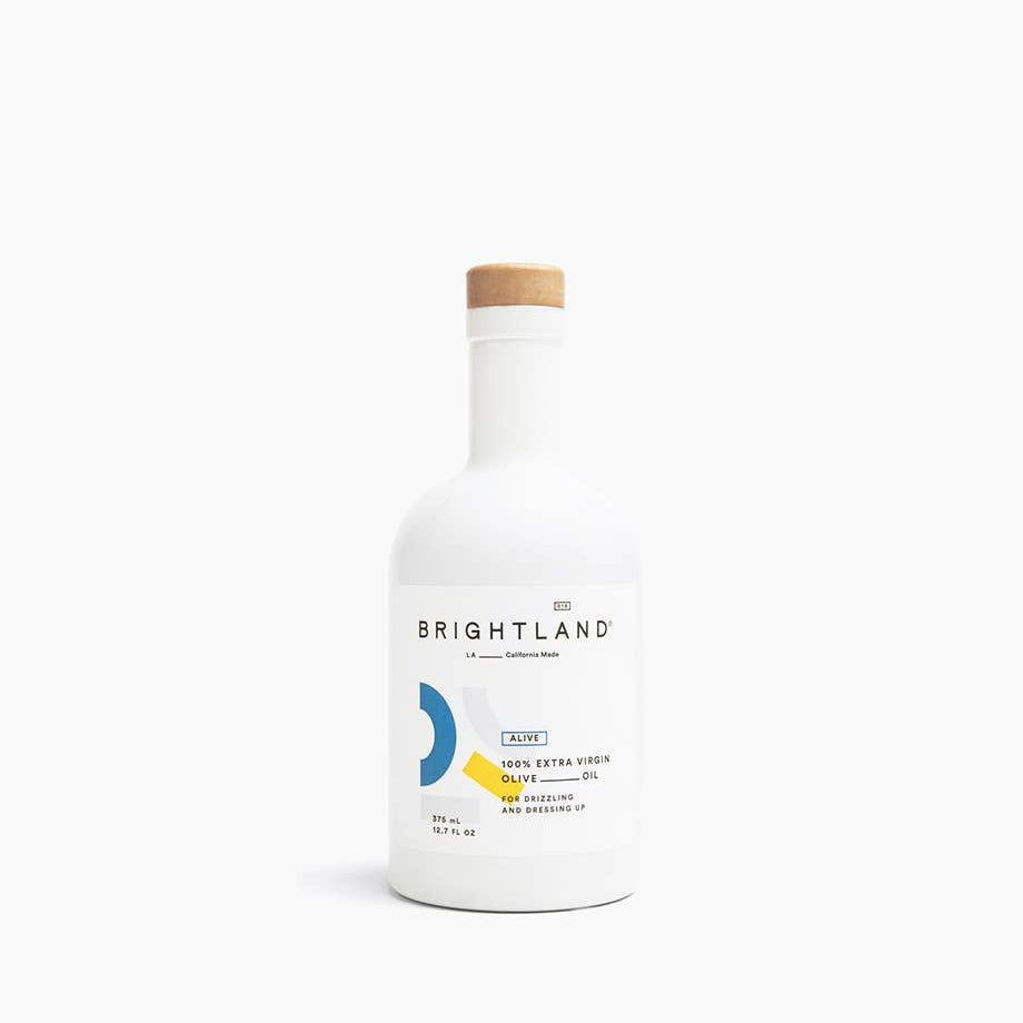 Bottle of Brightland olive oil on a white background