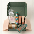 Wild Girl Gifts Adventure Edit gift box open showing S'well bottle, Handker bandana, Minori SPF, and trail snacks