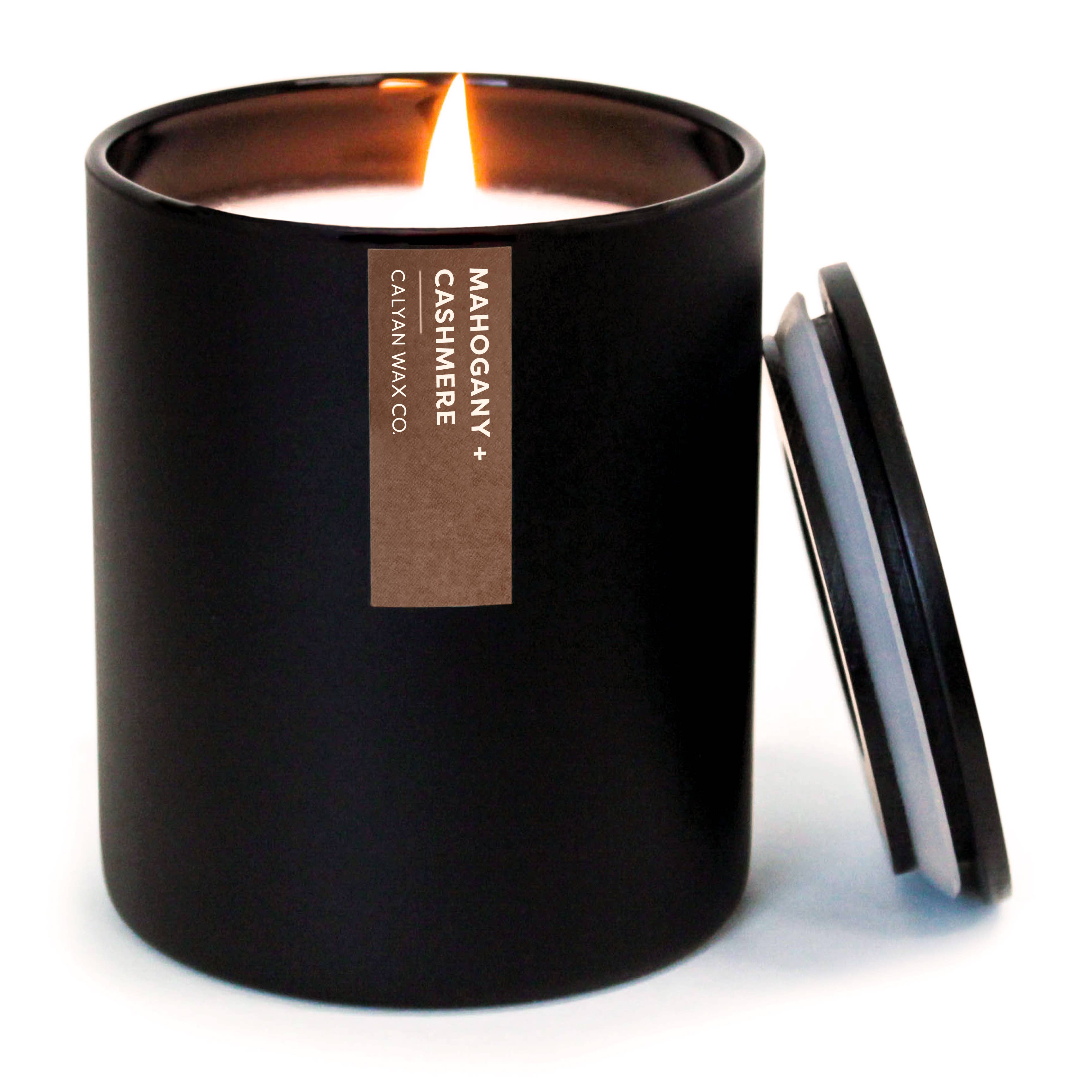 Black candle with a label on a white background