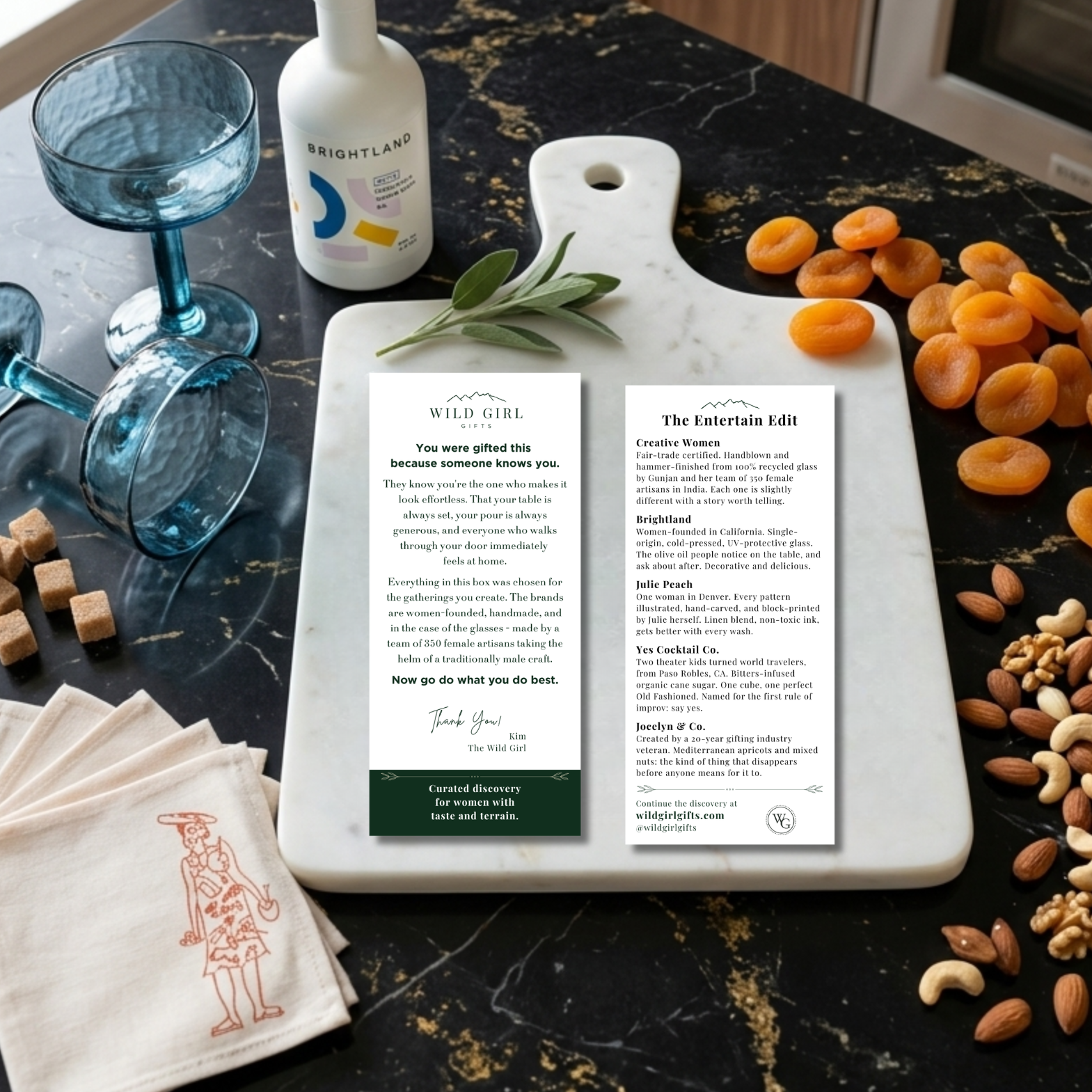 Kitchen counter with a cutting board, apricots, nuts, glasses, and a bottle of wine.
