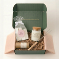 Wild Girl Gifts Wild Edit campfire gift box with Parks Project candle, marshmallows, trail mix, and Laugh S'more roasting stick