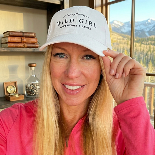 Kim wearing a 'Wild Girl' cap with a scenic background