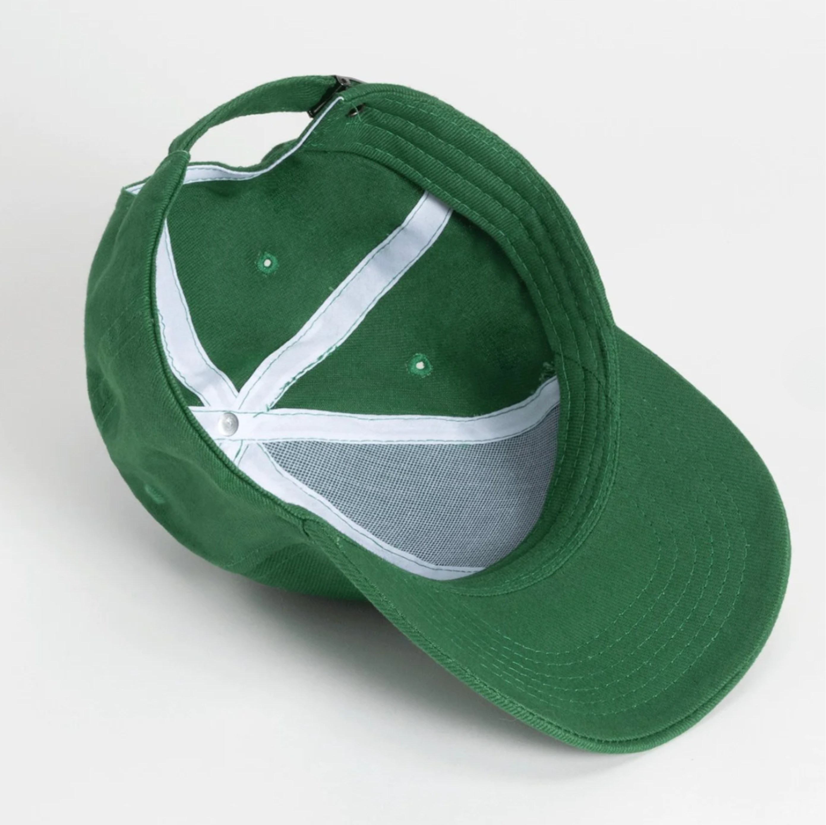 Green baseball cap with white mesh back on a light gray background