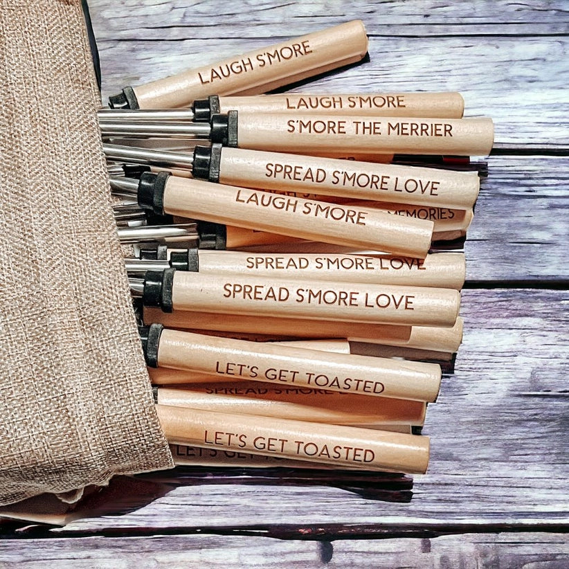Set of s'more sticks with humorous text on a wooden surface