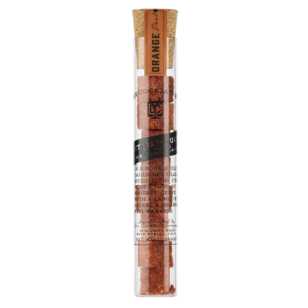 Spice stick in a clear tube with cork lid on a white background