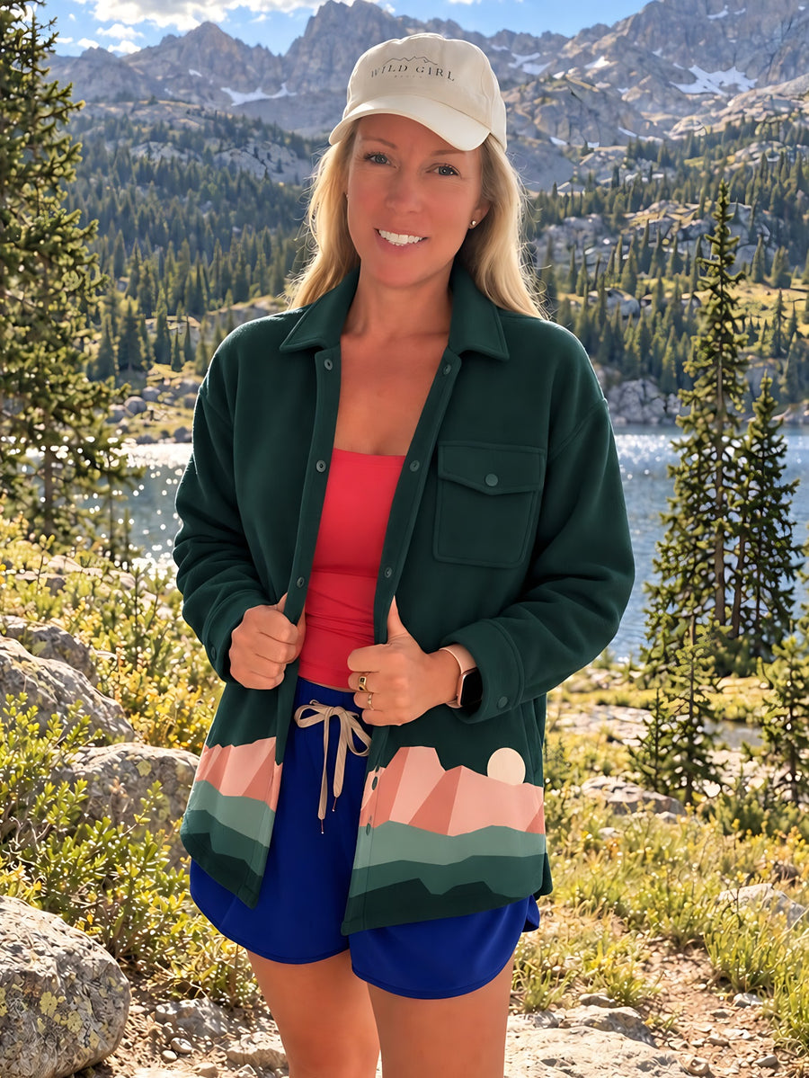 Trailhead Fleece Shirt Jacket in Spruce, worn open at an alpine lake (concept render)