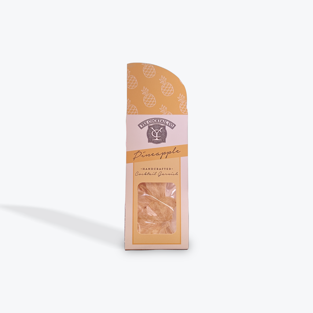 Packaged dried pineapple slice in a stand up pouch with a decorative label on a white background