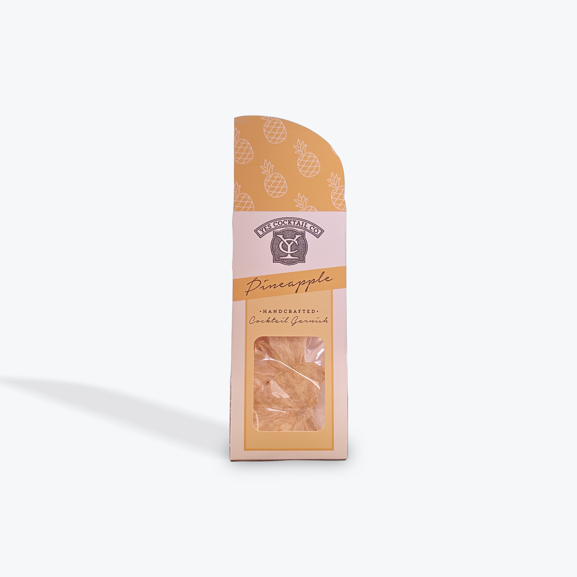 Packaged dried pineapple slice in a stand up pouch with a decorative label on a white background