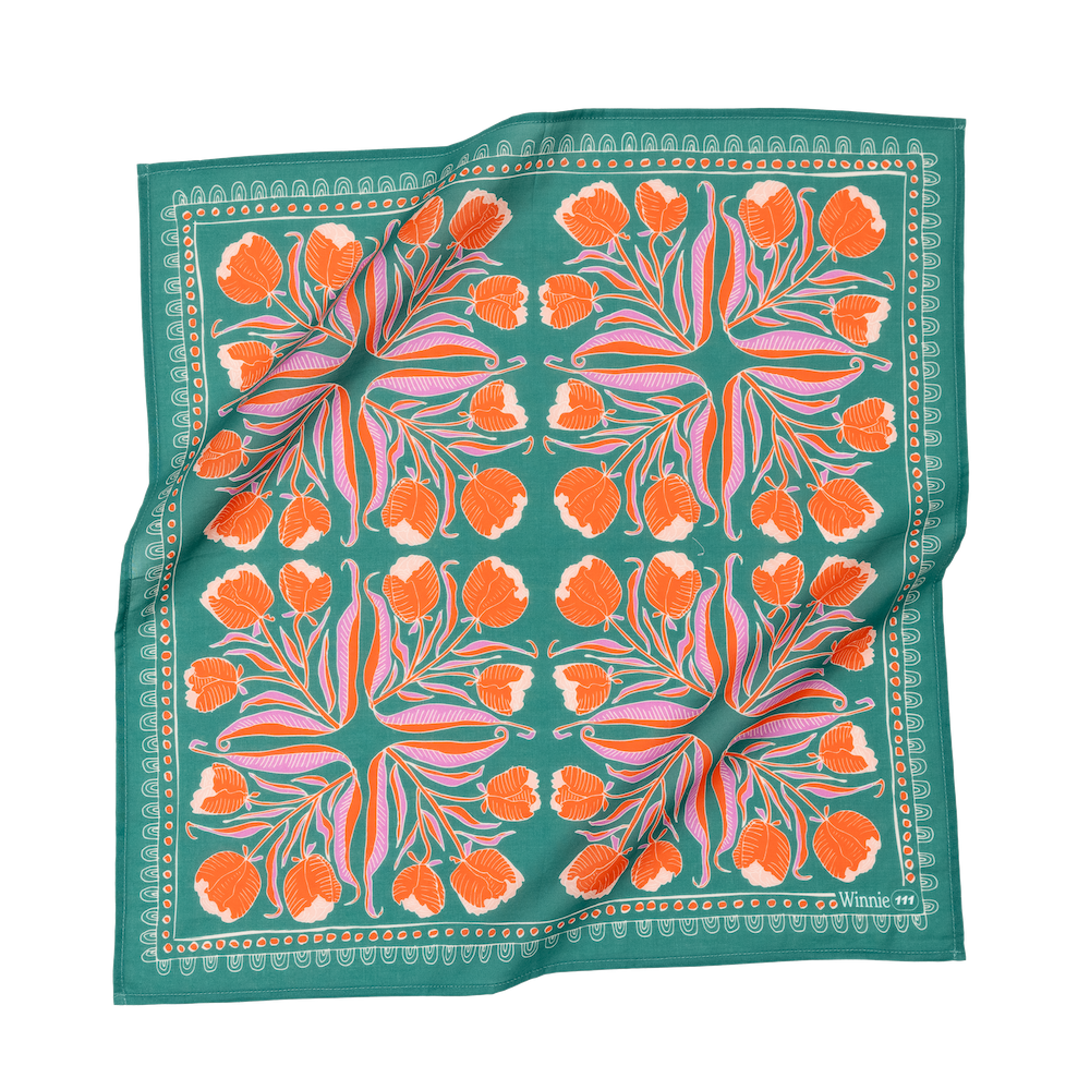 Floral patterned scarf with orange flowers on a green background