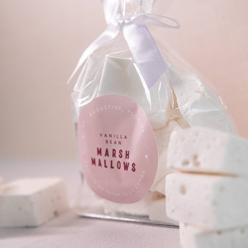 Bottle of vanilla bean marshmallows with a pink label on a light background