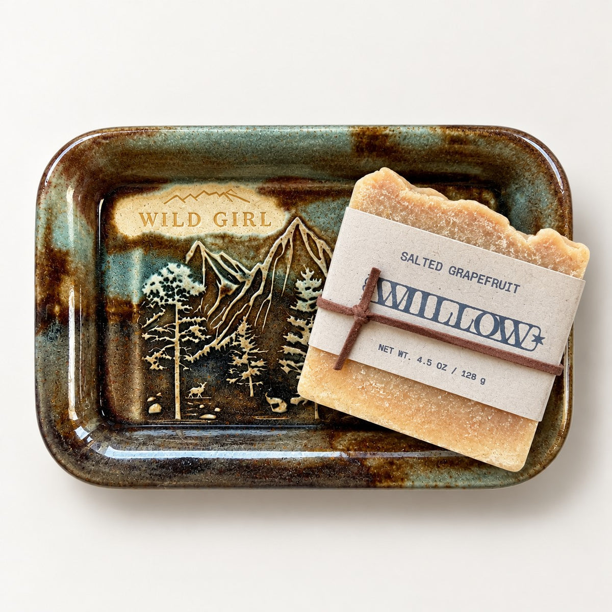 Wild Girl Rustic Brown ceramic soap dish holding a Willow Salted Grapefruit soap bar with a kraft label tied in brown cord.